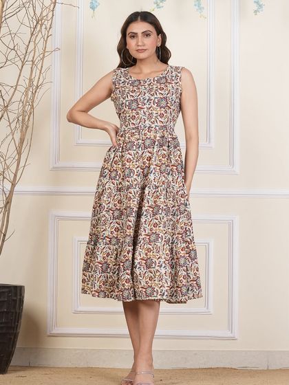 A neutral-toned tiered dress with an intricate all-over Bagru print. This versatile piece can be styled in many ways for different looks.