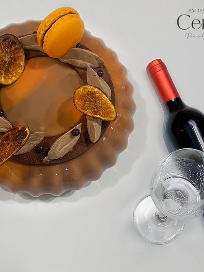 The Valencian Sunshine entremet pairs wonderfully with a glass of red wine, which enhances the chocolate's richness and the citrus's depth.