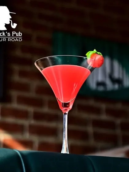 A classic red cocktail in a martini glass, garnished with a cherry. Simple, elegant, and absolutely delicious.