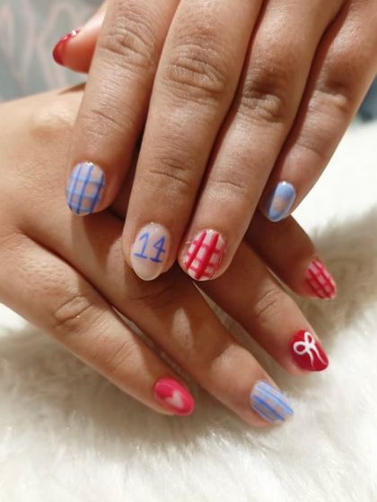 Fun and personal birthday nails. This client wanted a cute, custom design with plaid patterns, bows, and her age, "14", on the accent nail.