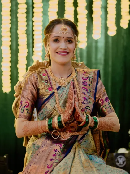 The bride in her multi-toned Paithani saree, ready for another ceremony. The makeup is soft and glowing, with a neutral lip to let the beautiful colors of the saree shine.