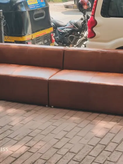 A two-piece brown leatherette sofa set, delivered to a client. This minimalist design is perfect for office spaces or modern apartments.