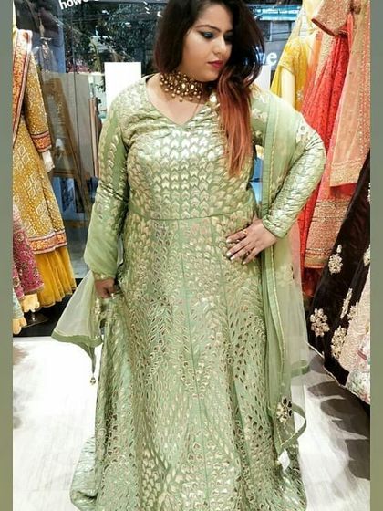 This customer looks stunning in a mint green Anarkali with all-over gold foil print. The full sleeves and flowing silhouette make it a comfortable and elegant choice for a long event.