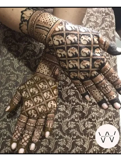 Henna is for everyone in the celebration. This intricate back-hand design, filled with detailed elephant figures and jaal patterns, was created for a special client celebrating Karwachauth.