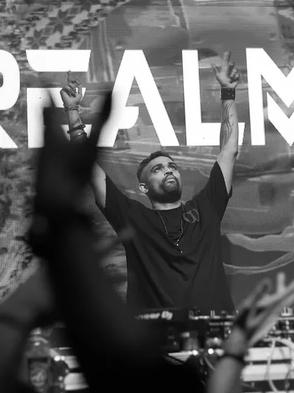 A black and white version of a powerful branding shot, with my hands raised in front of my logo.