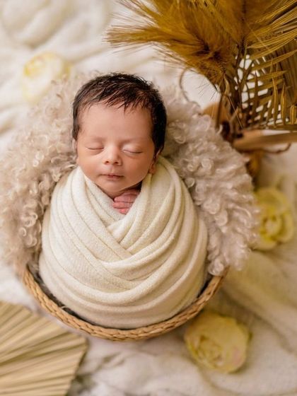 Wrapped in creamy white, this baby is the picture of serenity. I use a variety of wrapping techniques to create beautiful, clean portraits that focus on your baby.