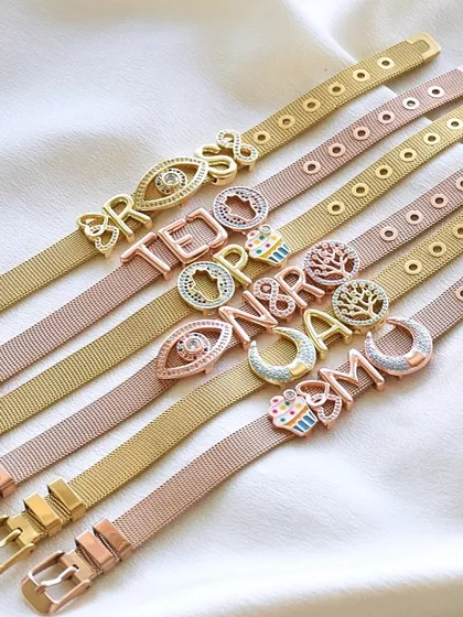 A whole collection of custom watchbelt bracelets, ready to be shipped out. I love seeing all the different names and charms you choose.