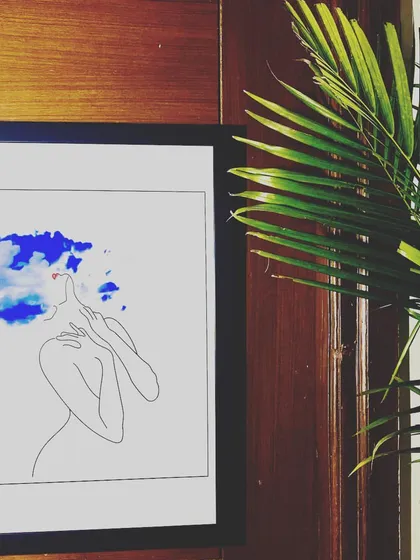 The apartment features unique and artistic decor, like this framed line art, to create a thoughtful and modern aesthetic.