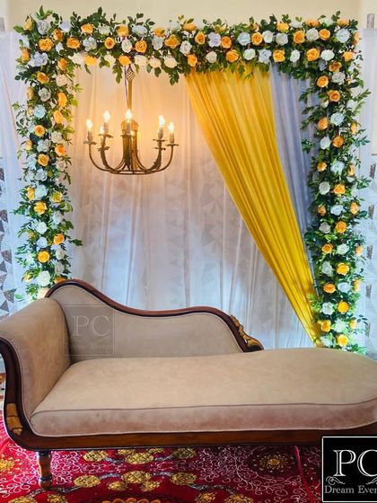 A closer look at the elegant ring ceremony decor, highlighting the intricate floral work and the warm light from the chandelier creating a perfect ambiance.