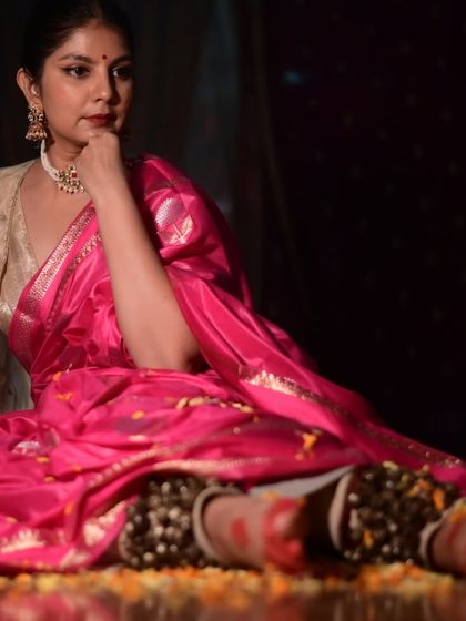 A reflective pose from a Holi-themed photoshoot. The rich pink saree and traditional ghungroos create a beautiful contrast, capturing the thoughtful side of the festival.