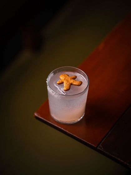 A festive Paradiso cocktail, served with a gingerbread man, captures the flavor of the holiday season.