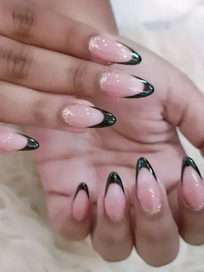 A full view of the elegant black French tips with a fine gold glitter accent line.