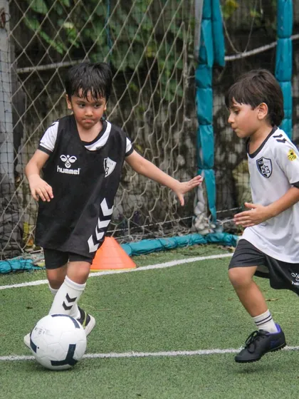 Two players challenge for the ball, showing the focus and determination required to win possession in a competitive drill.