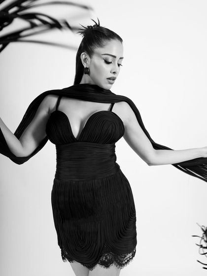 A beautiful shot that plays with the flowing scarf, creating elegant shapes and lines in monochrome.