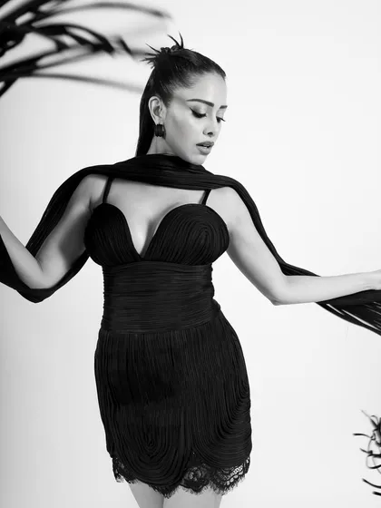 A beautiful shot that plays with the flowing scarf, creating elegant shapes and lines in monochrome.