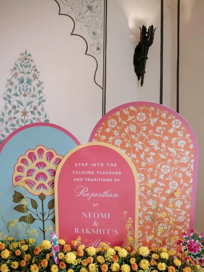 The welcome signage for the Rajasthani Mela, featuring beautiful floral and block-print inspired motifs. The sign invited guests to step into the colors, flavors, and traditions of Rajasthan.