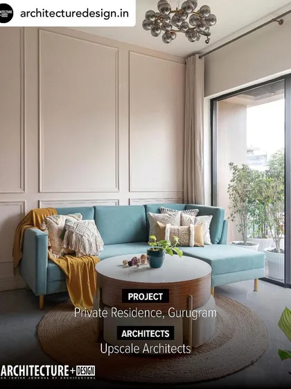 From the same Gurugram residence, the living room features full height glass doors that lead to a landscaped balcony. This design choice not only floods the space with natural light but also extends the living area into the outdoors.
