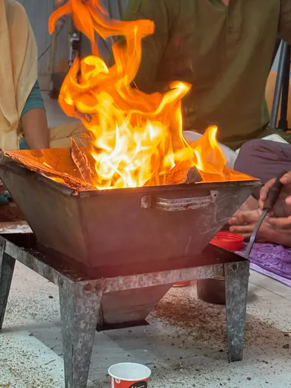 The vibrant flames of the Hawan, representing the transformative power of our shared spiritual practices.