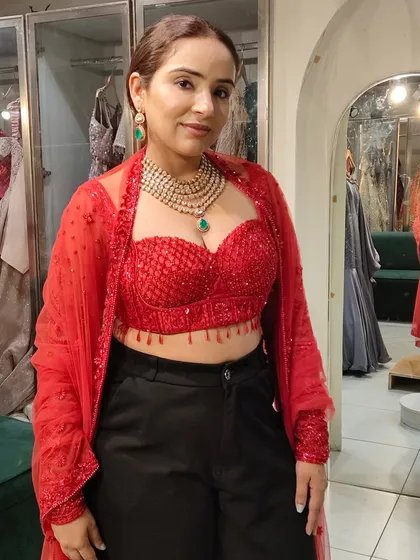 A client styles our layered emerald necklace with a modern red bustier and black pants. A perfect example of how to wear our jewellery for an indo-western look.