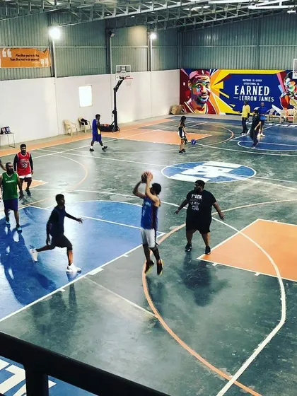 A high-angle view of a full-court game in progress. Our spacious indoor court can easily accommodate 5-on-5 games for your entire crew.