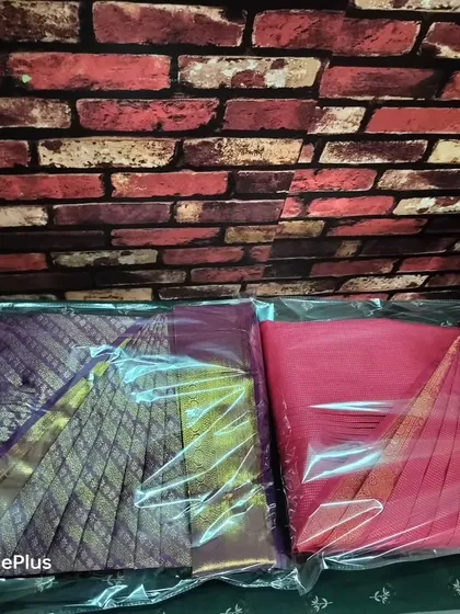 A close up of two packed sarees. You can see how the pleats are perfectly preserved inside the packaging.