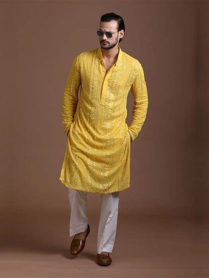 A bright yellow kurta with delicate sequin work. This is a perfect choice for a Haldi ceremony, offering a celebratory feel with a touch of glamour.