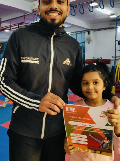 This student is happy to receive her "JUMP" program certificate.