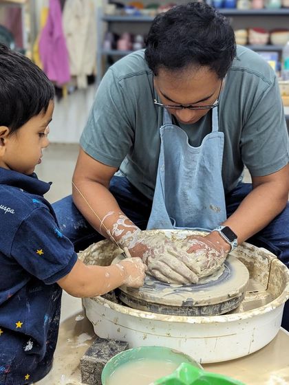 Little hands learning from big hands. We believe it's never too early to introduce children to the magic of pottery.