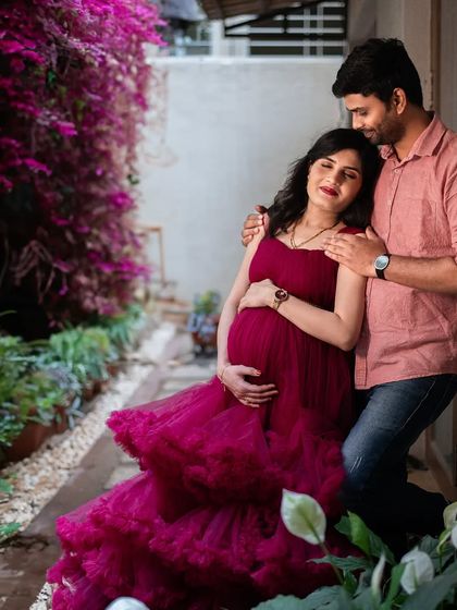 A tender embrace in a quiet garden corner. The flowing red gown adds a touch of drama and romance to this intimate couple's portrait.