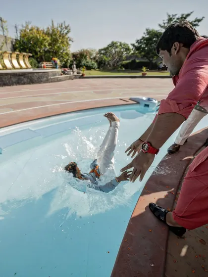 A hilarious, unexpected moment as a wedding guest is thrown into the pool. We are always ready for the madness and capture every bit of the fun.