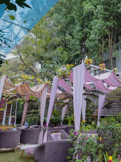 For a Haldi and Mehendi in a client's backyard, we used blush pink velvets for the canopies instead of conventional fabrics. The deep-colored furniture was chosen to break the monotony and add a touch of elegance.