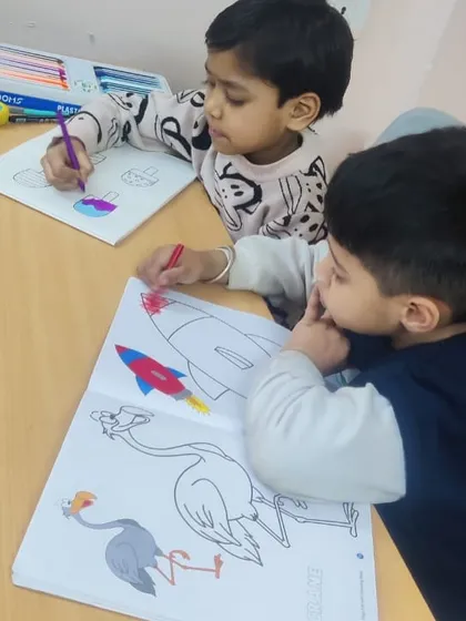 Our youngest artists working in a coloring book. This is a great way to introduce them to colors and help develop their motor skills.