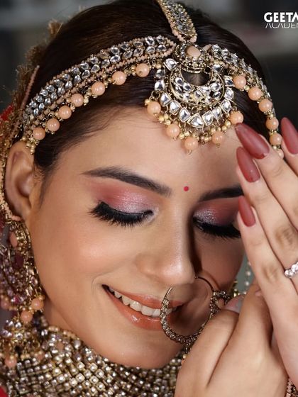 A joyful bride captured in a moment. This student's work highlights a beautiful pink-toned eyeshadow look, perfectly complementing the bride's attire and radiant smile.