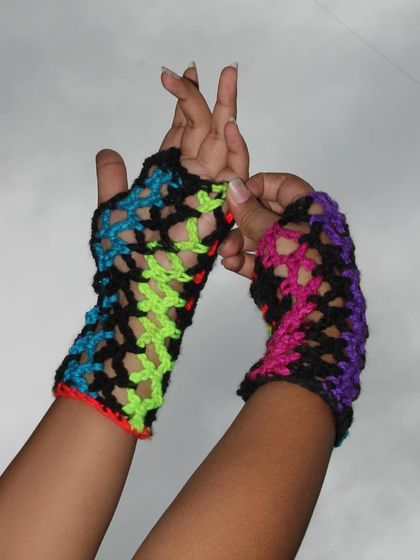 Showing both sides of the neon fingerless gloves. The pattern is different on each hand, making them a truly one-of-a-kind accessory.