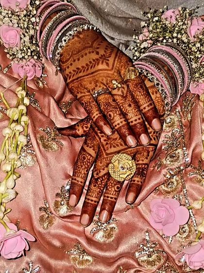 A beautiful 'Baat Pakki' (engagement confirmation) mehendi, surrounded by flowers. A perfect design for the start of wedding festivities.