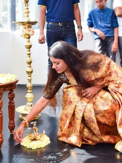 Lighting the lamp during the puja for the Nataraja idol, a sacred moment of inviting divine energy into my new space.