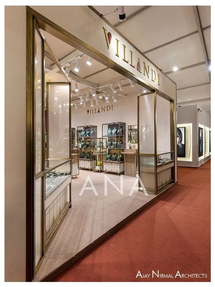 The open entrance of the Villandi booth, framed in brass, creates a seamless transition from the aisle into the retail space. The design ensures the stall feels both exclusive and accessible.