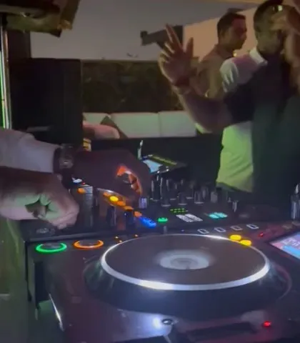 Another angle of me working the mixer. Precision and timing are key to creating a smooth and engaging set.