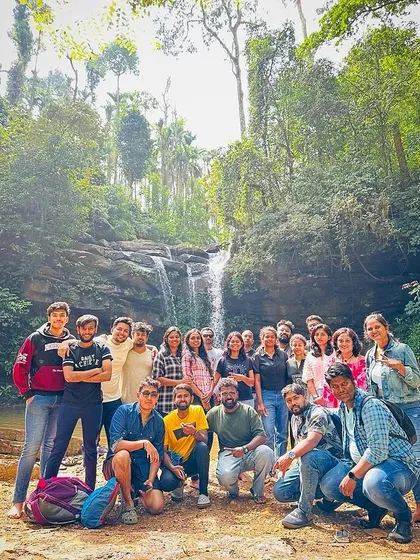 The New Year's batch posing for a group photo in front of a waterfall in Chikmagalur.