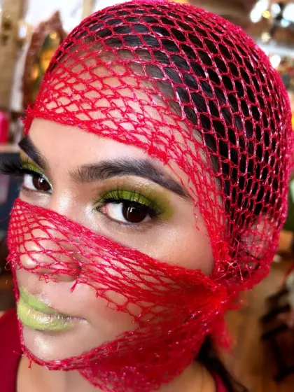 A close-up of the creative look, focusing on the bright green eyeshadow and lips.