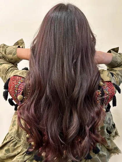 A view from the back showing the seamless blend of our 'wine on brown' highlights. Notice how the color is concentrated towards the ends for a modern, sun-kissed ombré effect.