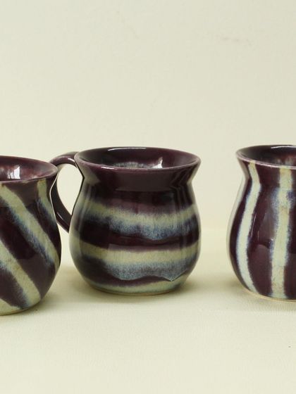 This collection of Alluring Amethyst cups shows the slight variations that make handmade pottery special. They are designed to bring a pop of color to your tea time gatherings.