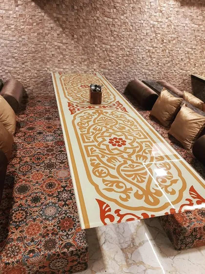A close-up of the beautifully designed low table in my Dastarkhwan area. The intricate patterns and comfortable seating make every meal feel like a special occasion.