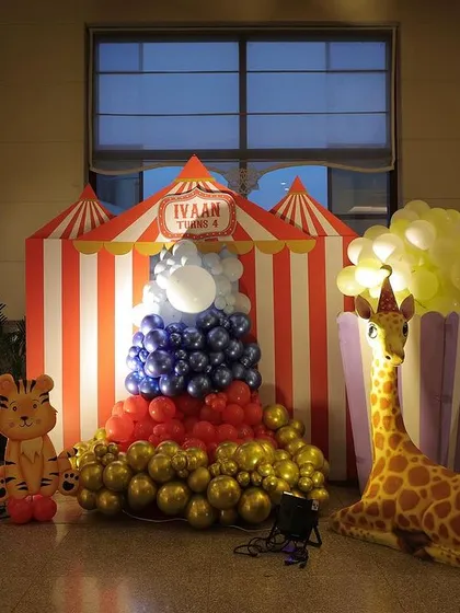 A fun decorative corner with a ticket booth prop, a popcorn box balloon sculpture, and various animal characters.