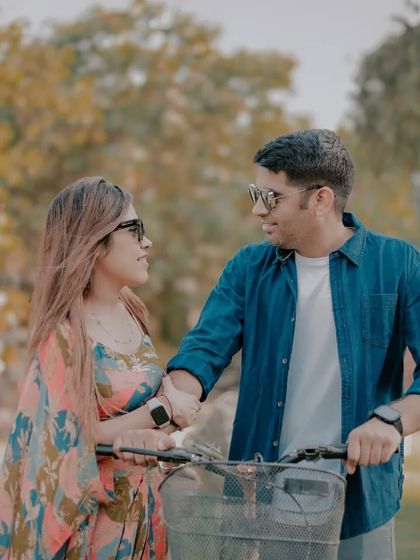 A casual and romantic shot of a couple walking with a bicycle on our lawn. The natural lighting and relaxed interaction make for a beautiful candid portrait.