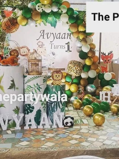 I can transform any space, even outdoors, into a party paradise. This 'Wild One' jungle safari setup was created for a first birthday, using a mix of green and animal-print balloons, character cutouts, and leafy decor to bring the jungle to life.