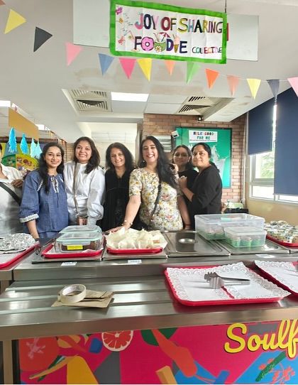 Parents and teachers at Shiv Nadar School run a food stall as part of the "Joy of Sharing Week," a celebration of empathy and action that supports our work.
