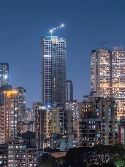 A mix of under-construction and completed skyscrapers defines this night view of the Mumbai skyline, highlighting the city's ongoing development.