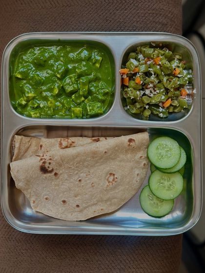 A classic combination of chapati and palak paneer, served with a side of sautéed French beans and cucumber. It's a great way to get your greens and protein.