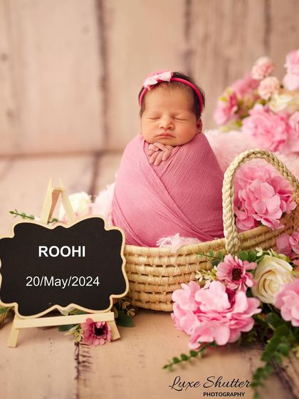 Announcing the arrival of baby Roohi. This newborn portrait features a personalized chalkboard, making it a perfect birth announcement photo.